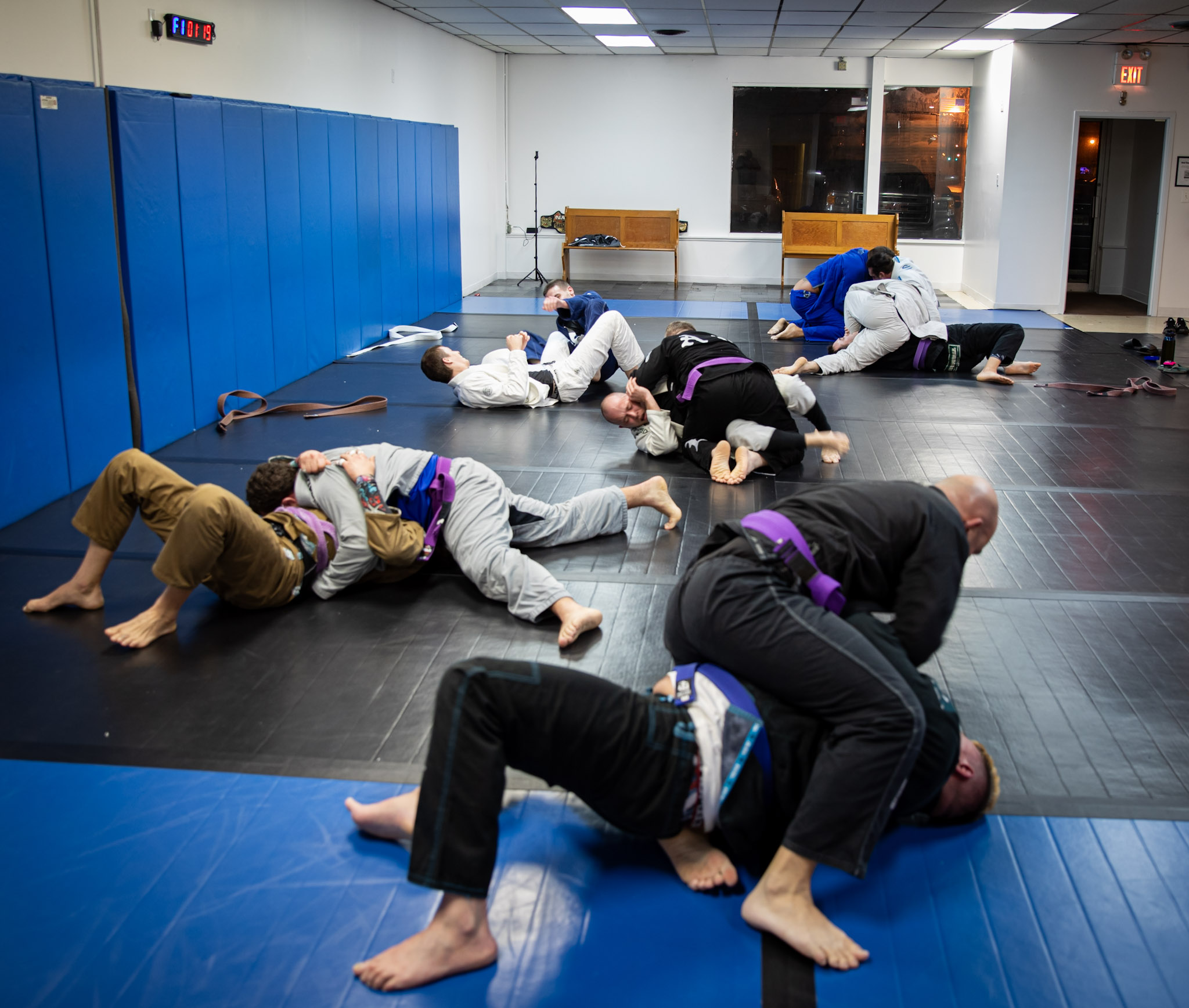 Adults practicing brazilian jiu jitsu