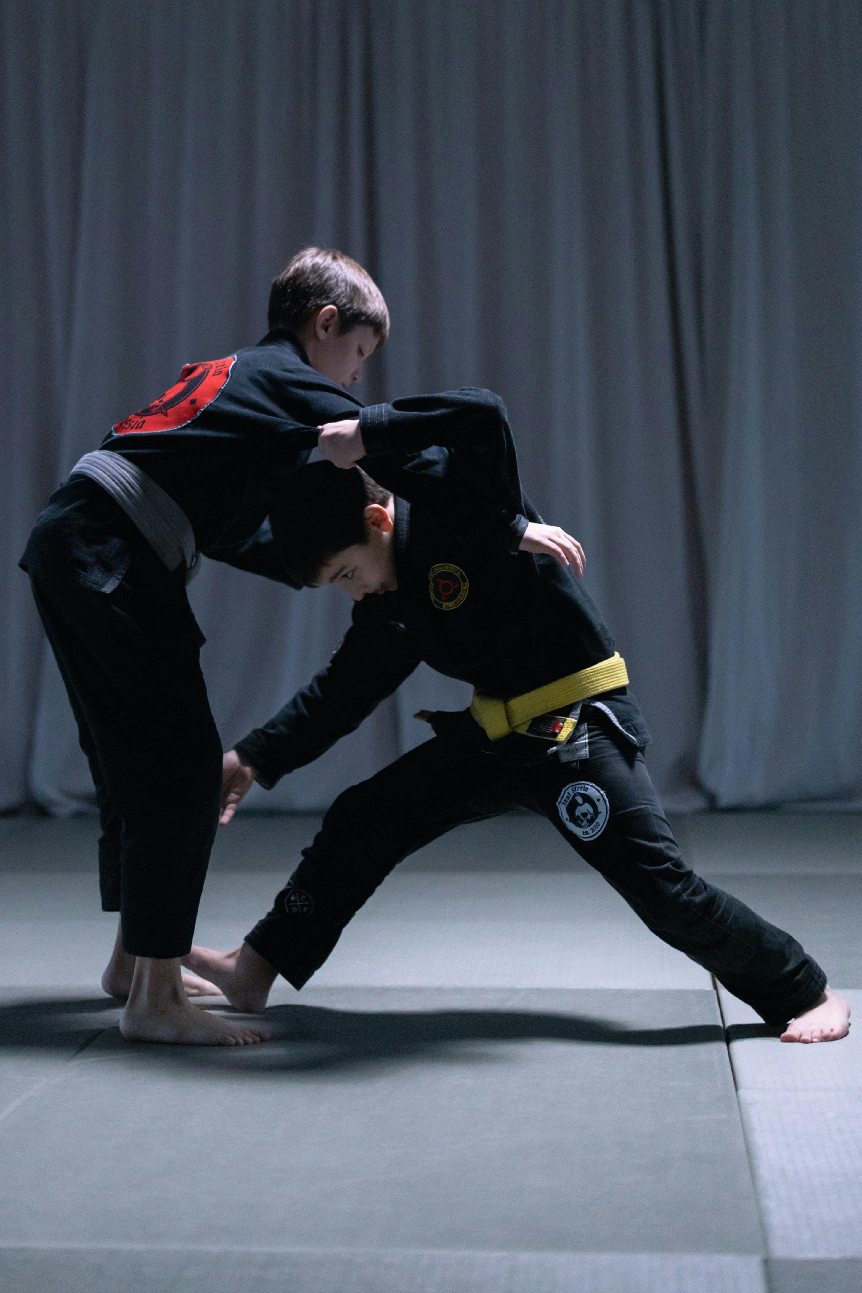 Two children practicing brazilian jiu jitsu