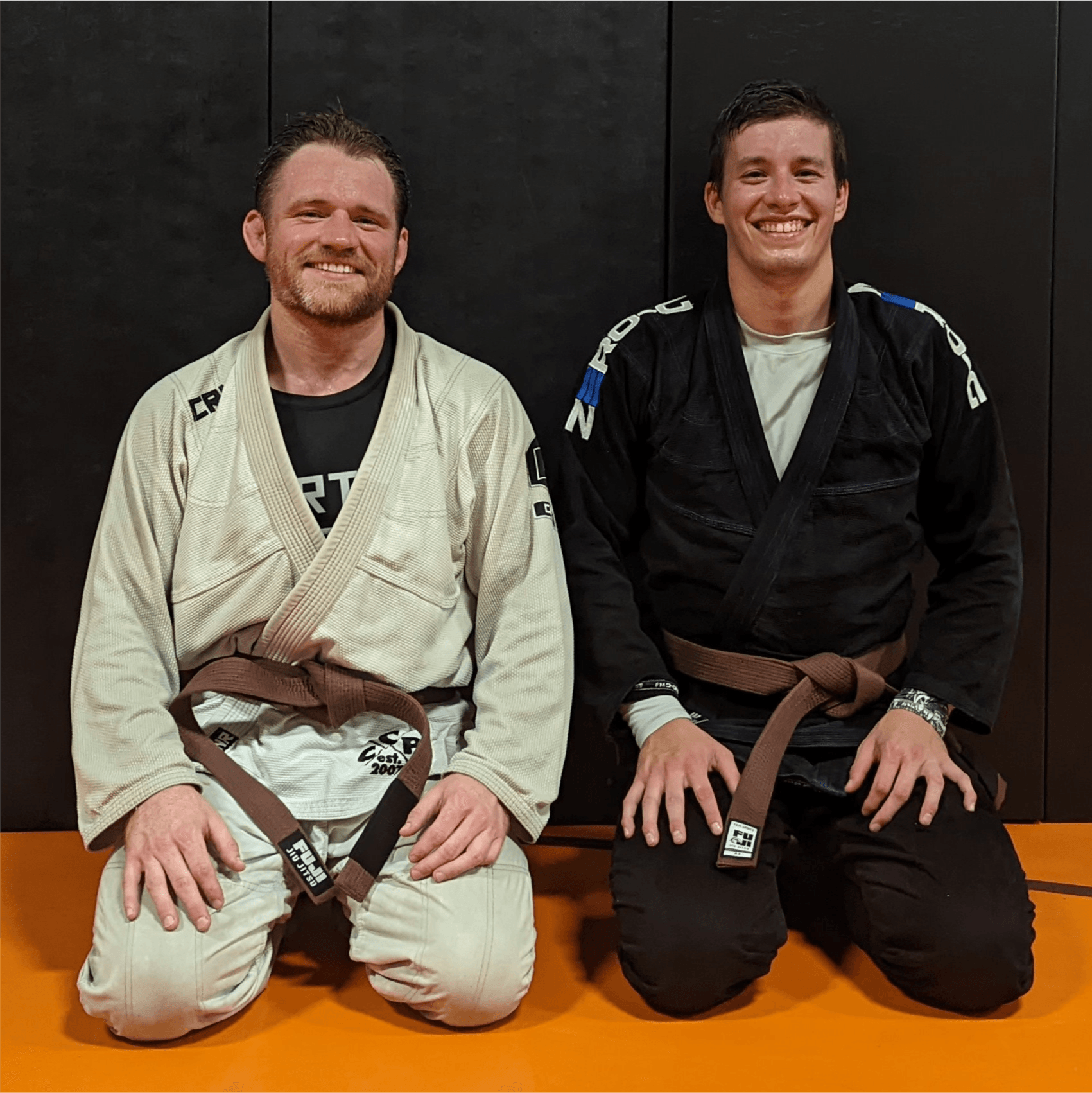 Mike Hudak and Adam Knipfer in a brazilian jiu jitsu gi