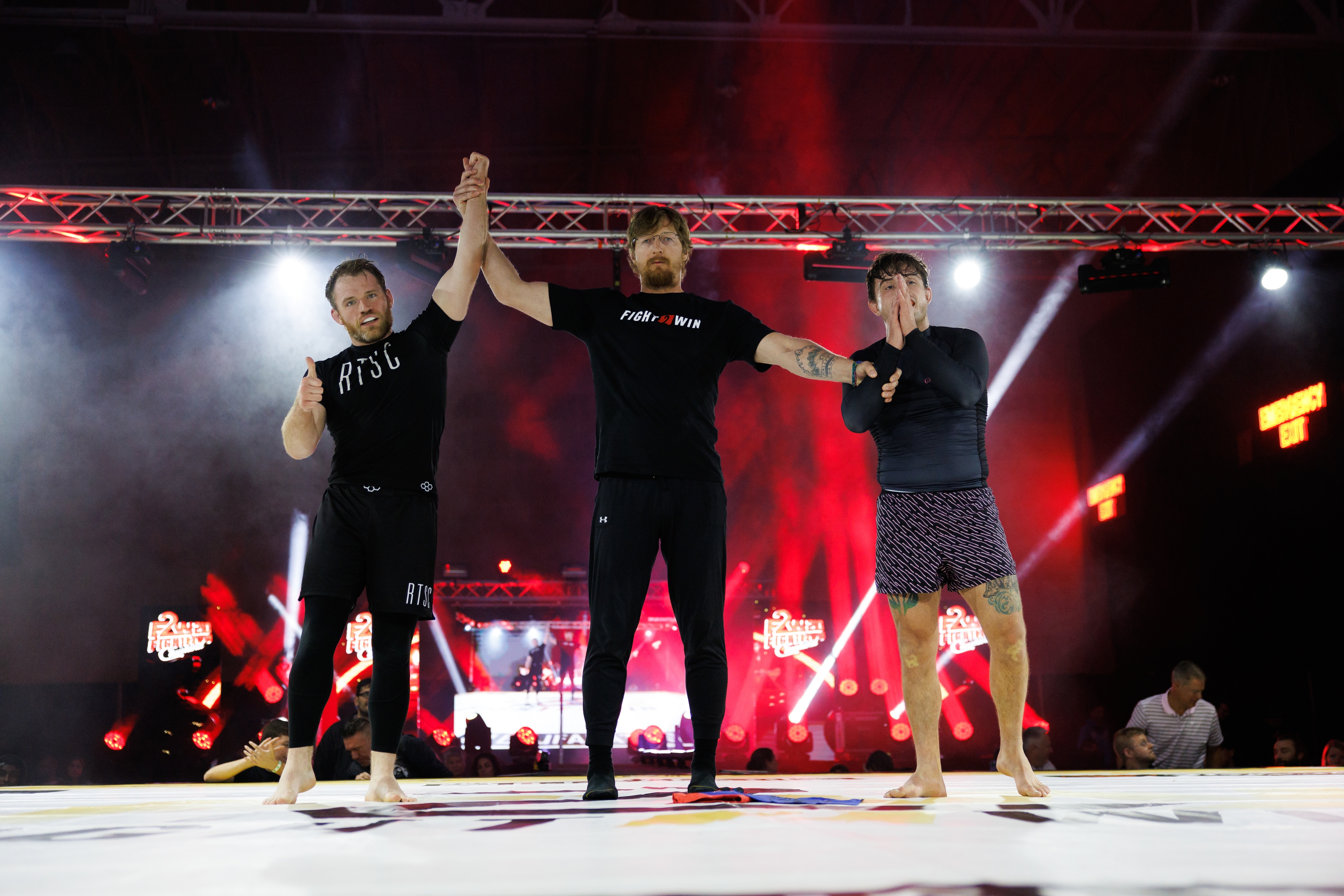 A hand being raised in a brazilian jiu jitsu competition